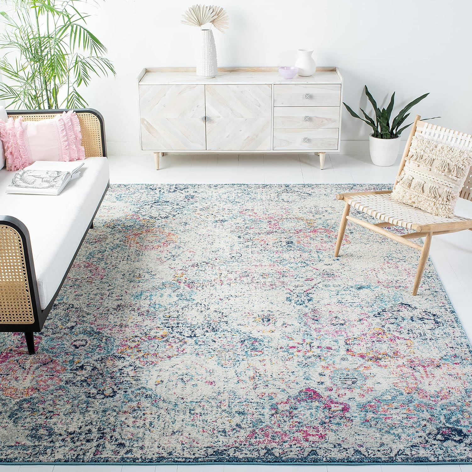 Was hesitant to purchase a rug sight unseen, but I decided to after reading so many great reviews. Its beautiful! Im still grabbing and setting up furniture, but attaching pics for others to see. I do not notice an odor, and the rug flattened out pretty quickly. For reference, I chose the navy/teal in the 5x7. It has pops of pink and yellow, but are muted enough to not be overpowering - just pretty.