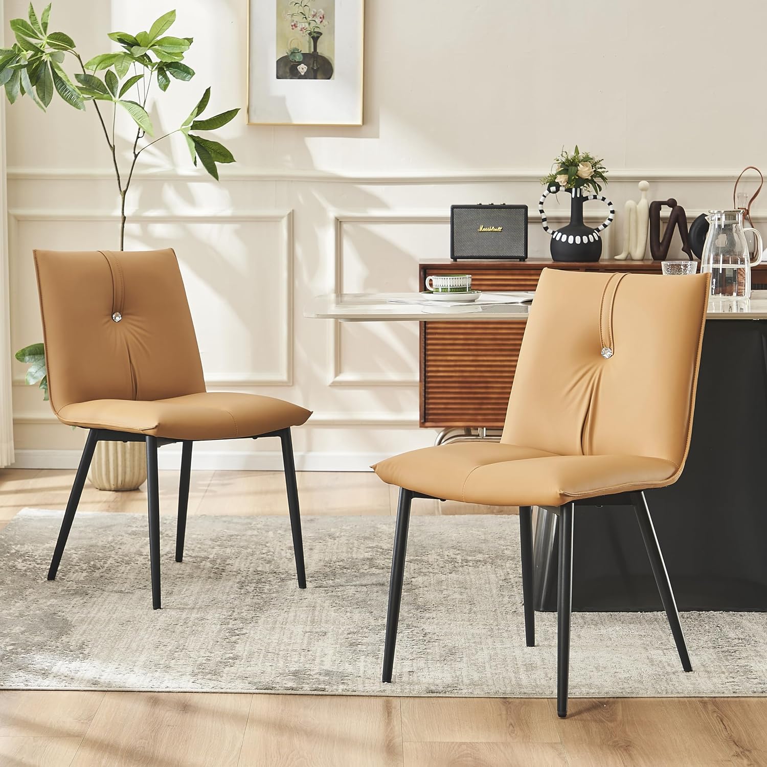 The YOUTASTE Dining Chairs Set of 2 has brought a touch of modern elegance to my dining space, exceeding expectations in terms of both style and comfort. These PU leather diamond-padded chairs seamlessly blend contemporary design with practical functionality, making them a standout addition to any kitchen, dining room, or reception area.The first thing that caught my eye was the sleek and stylish design of these chairs. The diamond-padded pattern on the PU leather upholstery adds a sophisticated touch, creating a visually appealing focal point. The black color complements a variety of interior styles, making these chairs versatile and suitable for various settings.Comfort is a priority when it comes to dining chairs, and the YOUTASTE chairs deliver in spades. The well-padded seat and back provide excellent support, allowing for a comfortable dining experience or relaxed conversation. The ergonomic design ensures that the chairs conform to the natural contours of the body, promoting long-lasting comfort during extended use.The metal legs not only contribute to the chairs' modern aesthetic but also provide sturdy and stable support. The robust construction instills confidence in the chairs' durability, and the metal legs add an industrial flair that elevates the overall design. The chairs feel solid and well-built, capable of withstanding daily use with ease.Assembly was a breeze, with clear instructions and all the necessary tools included. The chairs were ready for use in no time, reflecting the manufacturer' attention to user-friendly design. The lightweight construction also makes it easy to move the chairs around as needed.