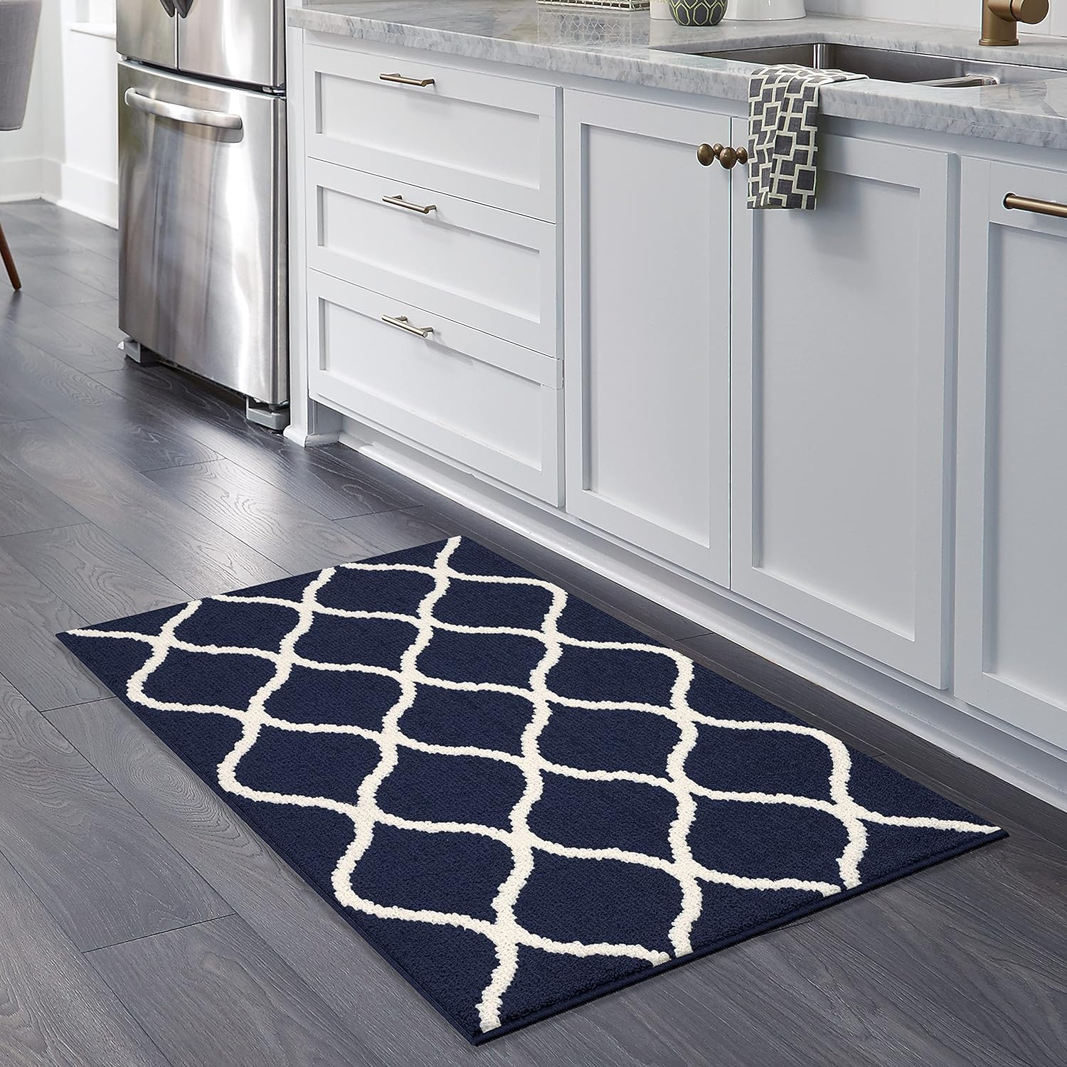 I hardly leave a review but this rug was better than expected! Even my daughter, who is picky, said it felt nice and soft when she stepped on it. It also matched the kitchen perfectly. This rug is well made, fits as stated, and appears to be durable. I was so impressed, I just ordered 2 of a different size to place in entryways! Love the design and the color choices available! You won't be disappointed and the cost for this size was great value! 5 stars