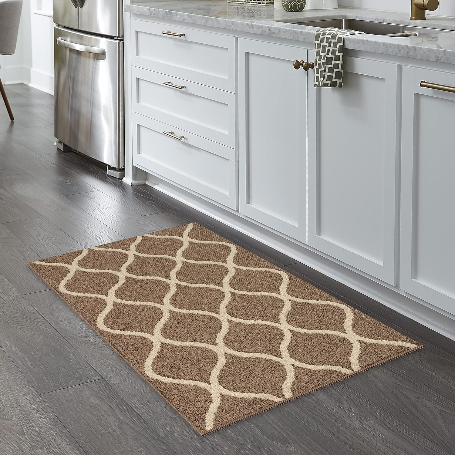 I hardly leave a review but this rug was better than expected! Even my daughter, who is picky, said it felt nice and soft when she stepped on it. It also matched the kitchen perfectly. This rug is well made, fits as stated, and appears to be durable. I was so impressed, I just ordered 2 of a different size to place in entryways! Love the design and the color choices available! You won't be disappointed and the cost for this size was great value! 5 stars